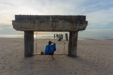 Old leaning cement pillars Cha-Am beach is a famous about a lot of old leaning cement pillars of the pier located in Cha-Am beach Phetchaburi, Thailand. clipart