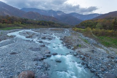 The observation deck from Hakuba Bridge offers a beautiful view of the Japan Alps and the beautiful stream on both sides of the bridge, which is hundreds of meters long, Hakuba Nagano, Japan clipart