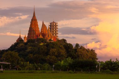 Beautiful view from outside of Wat Tham Sua, located on hill of Tha Muang District, Kanchanaburi Province, which is an ancient temple that is highly revered by the people of Kanchanaburi. clipart