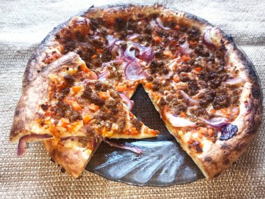 pizza with sausage and cheese on wooden background