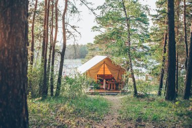 Glamping çadırı. Glamping seyahati. Ormandaki çadır evi. Kamp ve tatil konsepti.