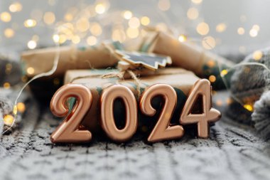Noel ve Yeni Yıl tebrik kartı. Örgü arka planda 2024 numara. Tatil ışıkları arka planda. Mutlu yıllar 2024.