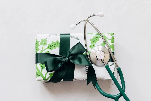 圣诞医药的概念 医疗听诊器和礼品盒 平躺在地上 俯瞰四周 免版税图库图片