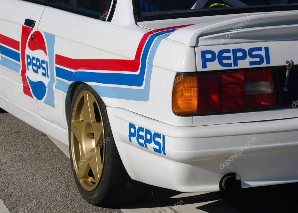 Rear part of a classic German sports car with American soft drink logo