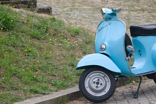 İtalyan bir imalatçıdan mavi bir scooter 'ın önünde, Avrupa ülkesinin simgesi ve simgesi.