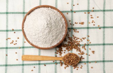 Buckwheat Flour Pile in Wood Bowl, Dry Buck Wheat Powder, Buckwheat Gluten Free Flour on Wooden Rustic Background Top View