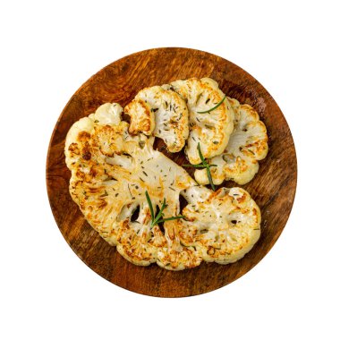 Fried Cauliflower Slices on Wood Plate Isolated, Baked Cauliflower Steaks, Roasted Cabbage Steak with Herbs Top View