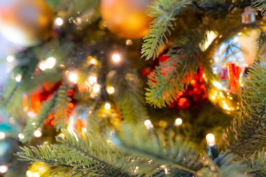 Decorated Christmas Tree, Christmas Decorations, Shiny Garland on Green Branches, Blurred Xmas Background with Copy Space