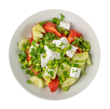 Greek Salad in White Bowl Top View Isolated. Fresh Garden Salat, Greek Salad with Green Onion, Feta Cheese, Tomatoes, Cucumber on White Background