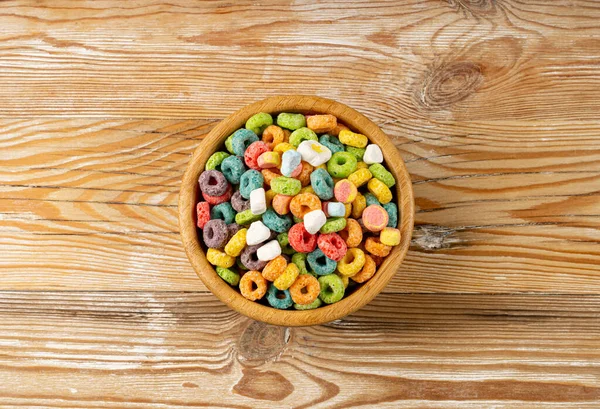 Colorful Breakfast Rings Pile, Fruit Loops, Fruity Cereal Rings with Marshmallows, Colorful Corn Cereals on Wood Background