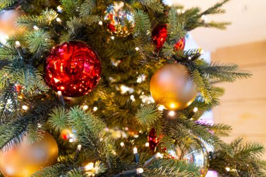 Decorated Christmas Tree, Christmas Decorations, Shiny Garland on Green Branches, Blurred Xmas Background with Copy Space