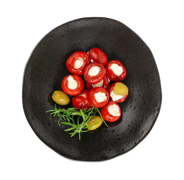 stock image Small Peppers Stuffed with Cheese, Cherry Pepper Filled Feta, Cream Cheese, Pickled Olives, Herbs, Vegetable Antipasti on Black Plate