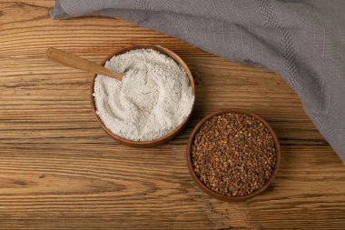 Buckwheat Flour Pile in Wood Bowl, Dry Buck Wheat Powder, Buckwheat Gluten Free Flour on Wooden Rustic Background Top View