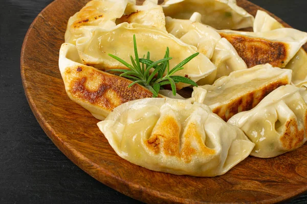 stock image Gyoza Chinese Dumplings on Wood Plate, Fried Vegetable Jiaozi Macro, Chicken Momo Pile, Asian Gyoza Group Closeup