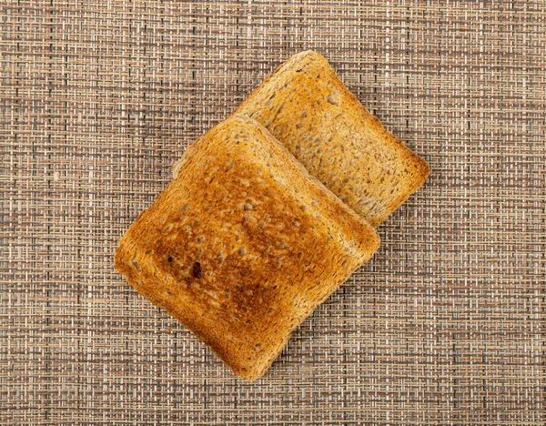素朴な背景のパントースト トーストサンドイッチスクエアスライス コピースペース付きブラウンテーブルクロスのトーストのための葉片 — ストック写真