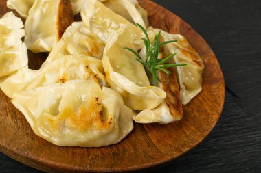 Gyoza Chinese Dumplings on Wood Plate, Fried Vegetable Jiaozi Macro, Chicken Momo Pile, Asian Gyoza Group Closeup clipart