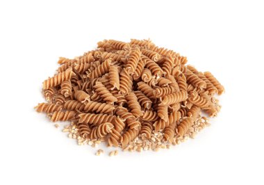Çiğ kahverengi makarna, kepekli fusilli istifi, tam tahıllı erişte, çiğ hamurlu makarna, sağlıklı İtalya yemeği, organik yemek, beyaz arka planda kepekli sarımsaklı makarna.