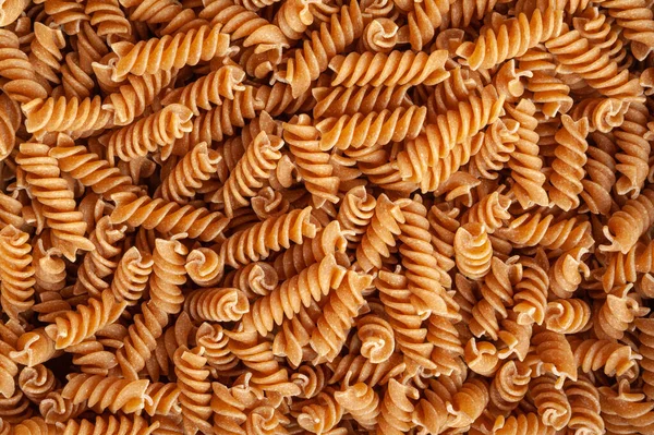 Rauwe Bruine Pasta Textuur Achtergrond Volkoren Fusilli Patroon Droge Volkoren — Stockfoto