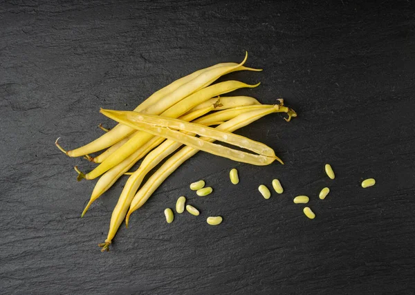 Yellow French Beans on Black Plate, Raw String Beans Pile, Fresh Wax Bean Pods on Dark Stone Background