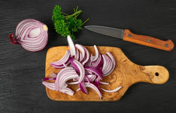 Red Onion Cuts, Raw Purple Onion Slices, Chopped Purple Onion Pieces on Cutting Board, Black Rustic Table Background Top View