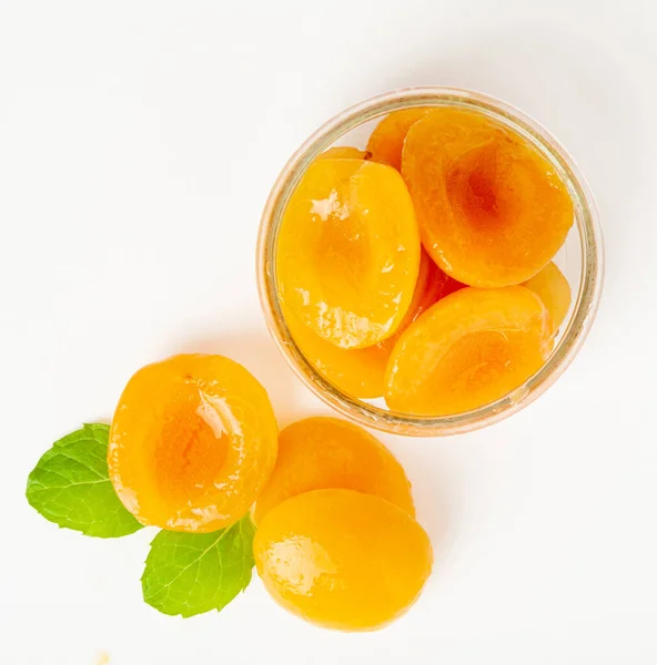 Canned Peaches in Bowl Isolated, Apricot Halves in Syrup, Yellow Fruit Dessert, Tinned Nectarine Compote, Orange Peeled Peache Slices on White Background