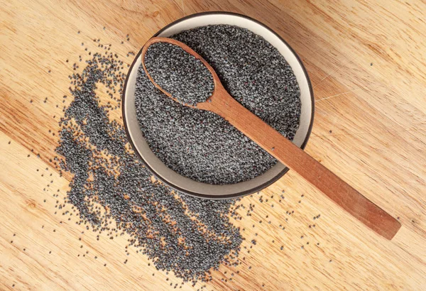 Poppy Seed in Bowl, Blue Poppyseed Pile in Wood Spoon, Small Culinary Grains, Tiny Seeds, Oilseed Sprinkles for Cooking, Poppy Seed on Wooden Rustic Background