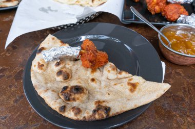Hint Düz Ekmek ve Tavuk Haryali Tikka, Izgara Tavuk Parçaları, Geleneksel Pita Ekmeği, Roti Porsiyonu, İnce Chapati, Naan veya Hint Restoranında Tortilla olarak da bilinir.