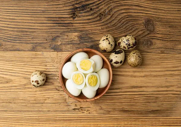 Peeling Diet Egg from Shell, Peeled Quail Eggs on Wood Plate, Healthy Breakfast, Natural Organic Nutrition, Salad Ingredient Spotted Quail Egg on Rustic Background