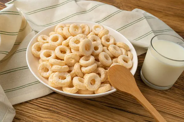 Cereal Rings on Wooden Table, Breakfast Rice Loops, Corn Cereals Snack on Rustic Background