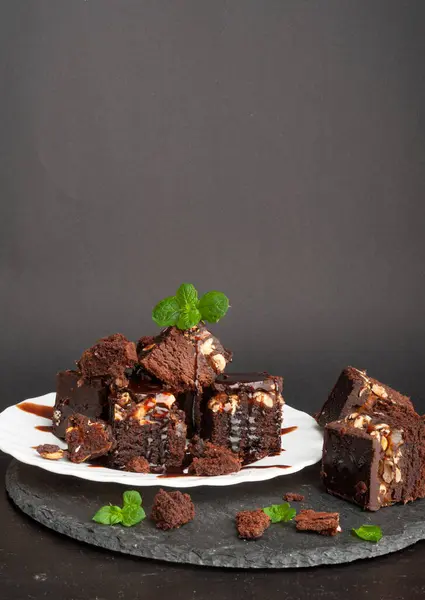 Nut Brownie, Homemade German Chocolate Cake, Chocolate Peanuts Cake, Brownie Square Piece on Black Stone Background