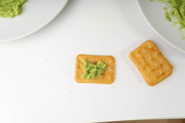 Avocado Smear Toast, Cracker Isolated, Sharwil Puree, Brown Avocados Paste, Fresh Alligator Pear Cream, Guacamole Paste, Persea Americana Avocado Fruit Sauce on White Background clipart