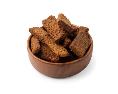 Rye Croutons in Wood Bowl Isolated, Homemade Brown Bread Rusks, Crispy Bread Cubes Scattered Pile, Dry Rye Crouoton Crumbs, Brown Roasted Salted Crackers on White Background clipart