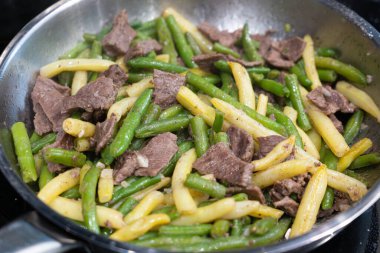 Stir Frying Beef with Green Yellow String Beans Closeup, Fried French Beans Mix with Meat, Asian Food on Blurred Background, Selective Focus clipart