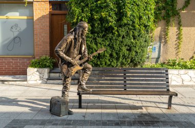 Suwalki, Poland, August 27, 2024 Monument to a musician playing the guitar in Suwalki Old Town, Podlaskie Voivodeship editorial image clipart