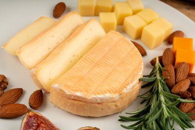 Munster cheese, stinky french cheese, creamy dairy product, gourmet food, orange round cheese closeup clipart