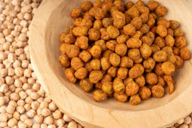 Roasted chickpeas close up, leblebi pile, spicy fried chana, macro crispy chick peas with mint and spices, traditional oriental spicy snack in wood bowl clipart