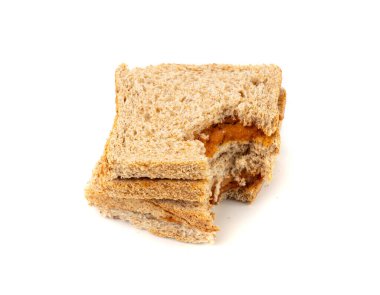 Isırılmış ezmeli sandviç izole edilmiş, düşük kalitede yemek artıkları, kötü kalitede kızarmış ekmek, arka planda kötü fıstık ezmesi tadı.