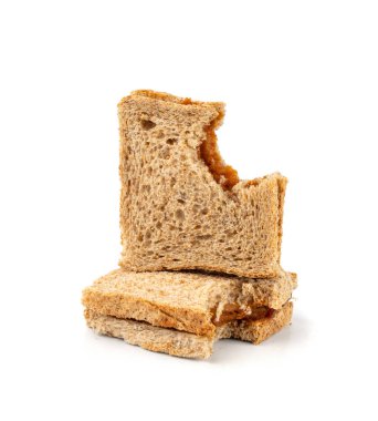 Isırılmış ezmeli sandviç izole edilmiş, düşük kalitede yemek artıkları, kötü kalitede kızarmış ekmek, arka planda kötü fıstık ezmesi tadı.