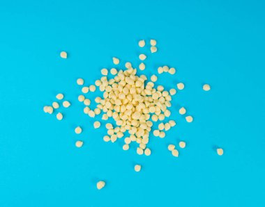 Beyaz çikolata parçaları, dağınık beyaz çikolata serpintileri, dekoratif kakao damlaları, Morsels, Kurabiye Dekorasyonu, Mavi Arkaplan Üst Görüş 'te Küçük Şekerleme Çipleri Parçaları