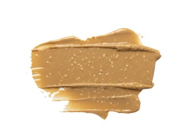 Tahini smear yalıtılmış, susam ezmesi sıçramış tahina sosu dökülmüş, doğu sosu dökülmüş, geleneksel doğu mutfağı malzemeleri dökülmüş, zemin susamı beyaz arka planda.