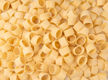 Çiğ Calamarata Big Pasta Doku Arkaplanı, Ev Yapımı Kuru Makarna Deseni, Pişmemiş İtalyan Yuvarlak Erişte Banner, Kopya Space Top Manzaralı Calamarata Makarna Halkaları