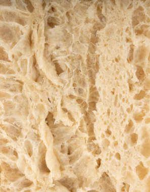 Focaccia yassı ekmek dilimi makro doku, fırında hamur deseni. Beyaz ekmek somunu yakın kes, buğdaylı tost dilimi arka plan, sünger fırın afişi yakın plan ve fotokopi alanı ile üst manzara