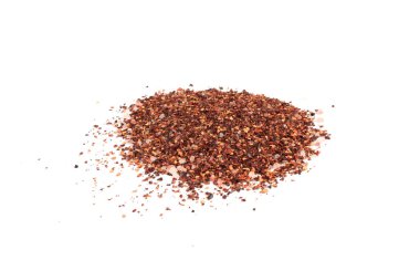 Chili and salt seasoning pile isolated, red chilli pepper spice powder, dry crushed hot pepper flakes with seeds on white background