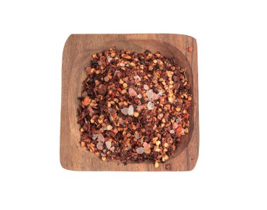 Chili and salt seasoning pile isolated, red chilli pepper spice powder, dry crushed hot pepper flakes with seeds on white background
