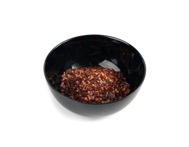 Chili and salt seasoning pile isolated, red chilli pepper spice powder, dry crushed hot pepper flakes with seeds on white background