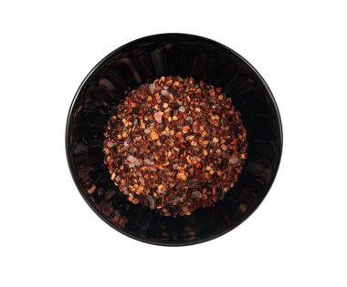 Chili and salt seasoning pile isolated, red chilli pepper spice powder, dry crushed hot pepper flakes with seeds on white background