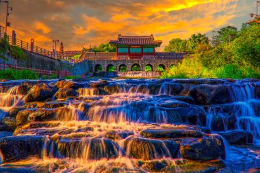 Banghwasuryujeong Pavilion and Hwahong Mun Gate at sunset in Suwon, South Korea. clipart