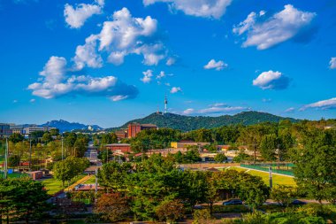 Beautiful view of Namsan Seoul Tower on Namsan Mountain in Seoul, South Korea. The tower is a popular tourist attraction in Asia, and the city has a bright and beautiful view. clipart