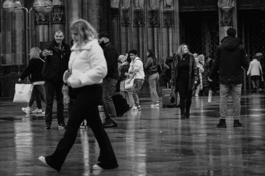 Cologne, Germany - October 27, 2023: A bustling square near Cologne Cathedral fills with pedestrians, each moving through the winter air with purpose.  clipart