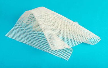 Anti-Slip Underlay to Prevent Rugs from Moving, Rubber Mesh for Placing Under Carpet on Blue Background Top View